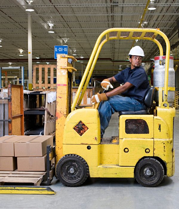 Man in a forklift in a warehouse reversing safetly